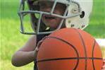Little Boy with Football Helmet and Basketball